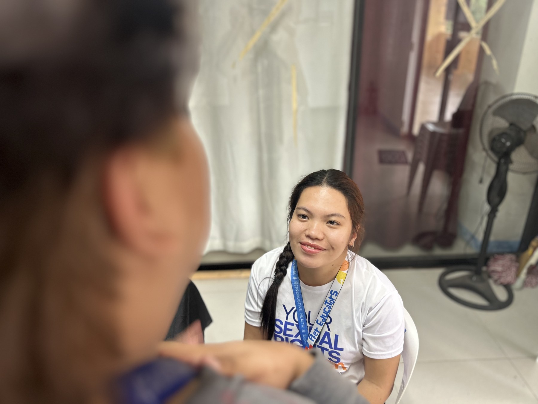 A CAPE peer educator listening to a young person